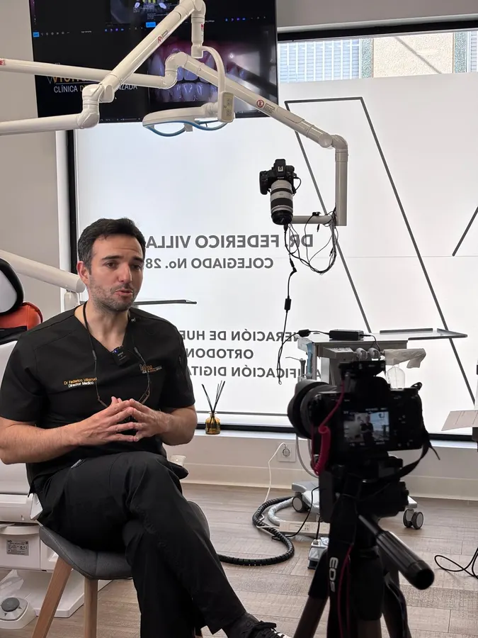 A dentist filming on camera with the production crew